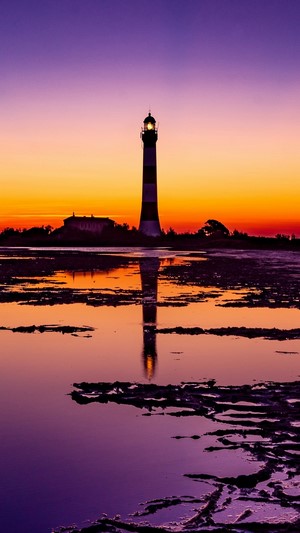 Lighthouse at Sunrise with Reflection