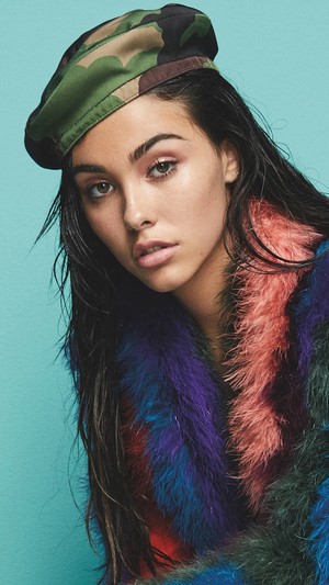Madison Beer wearing a camouflage beret and colorful fur coat