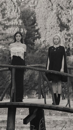Red Velvet members on a wooden bridge
