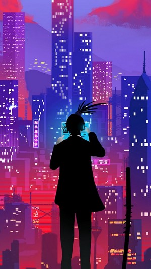 Silhouette of a person looking at a screen in a neon city at night