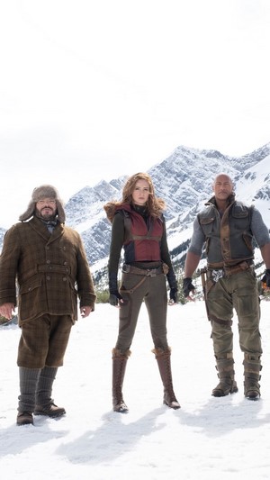 Characters from Jumanji The Next Level in snowy mountains