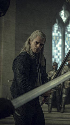 Geralt from The Witcher holding a sword