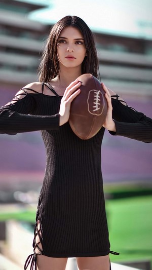 Kendall Jenner holding a football