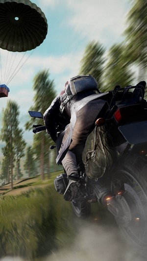 Player on Motorcycle with Supply Drop in PUBG
