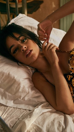 Camila Cabello lying on a bed