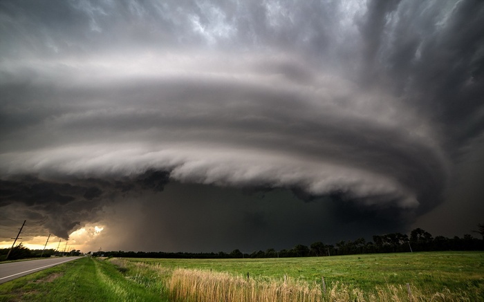 Supercell storm cloud over a rural landscape