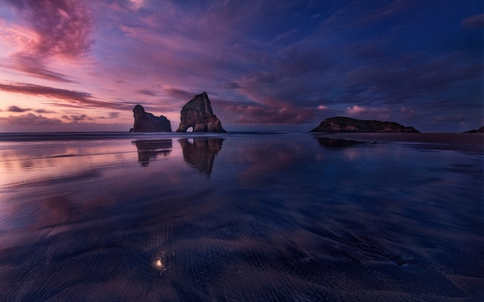Rocky Archways on a Beach at Sunset