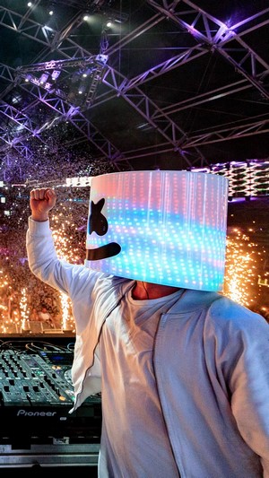 DJ Marshmello performing live with confetti and fireworks