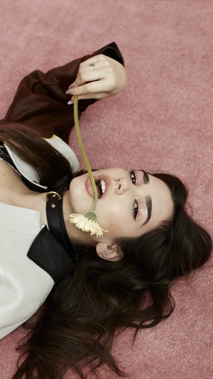 Dua Lipa with a flower