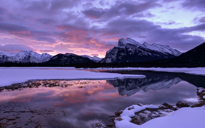 Snowy Mountains Reflected in Water at Sunset