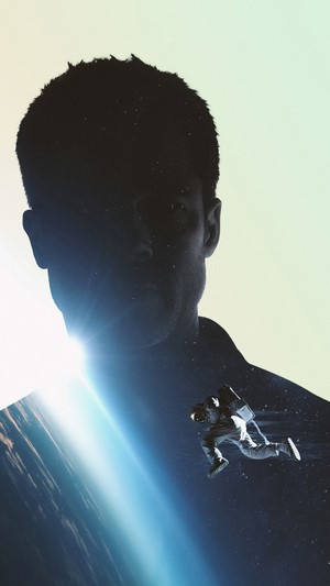 Astronaut floating in space superimposed on a man's silhouette