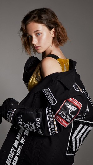 Cailee Spaeny in a black jacket with patches