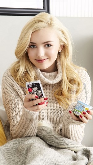 Peyton List holding a phone and yogurt