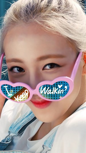 Yuna from ITZY wearing heart-shaped sunglasses