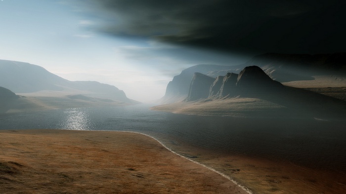 Misty mountains and a lake under dark clouds