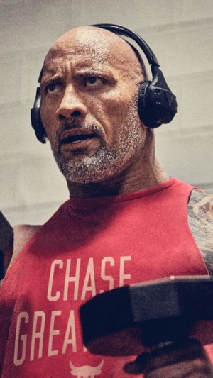 Dwayne Johnson wearing headphones and tank top