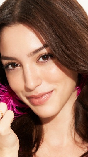 Celine Farach with pink feather earrings