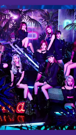 TWICE members in a neon-lit jungle setting