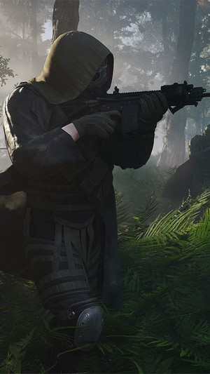 Soldier with rifle in forest