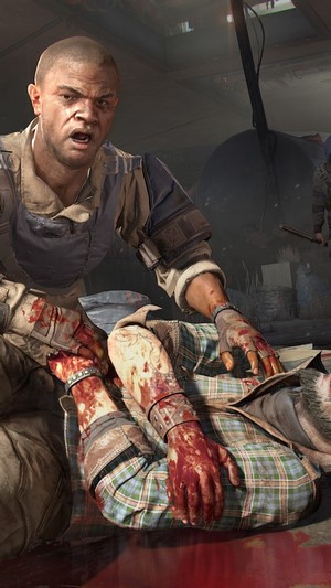 Man tending to bloody injured person in Dying Light 2