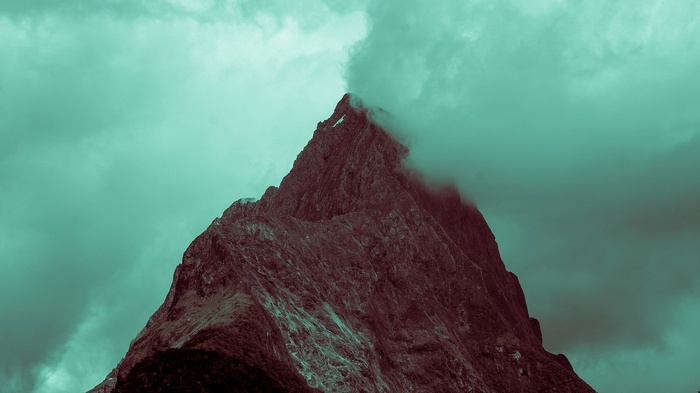 Jagged mountain peak shrouded in mist