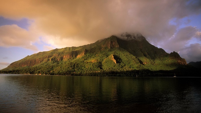Mountain range with clouds over water