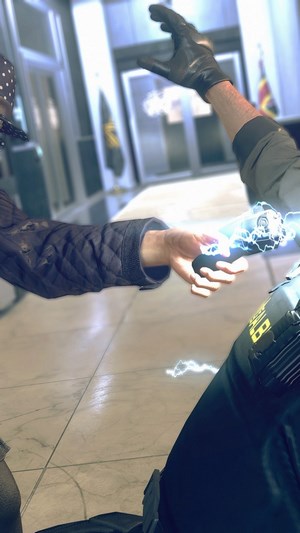 Helen from Watch Dogs Legion using a stun device