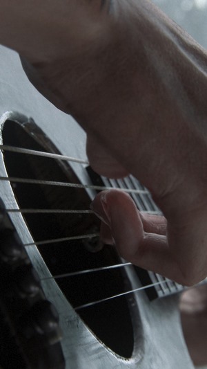 Ellie from The Last of Us Part 2 playing guitar