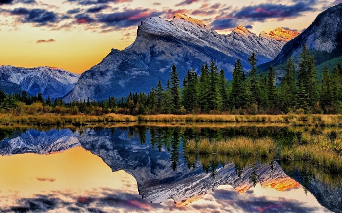 Mountain range reflected in a lake at sunset