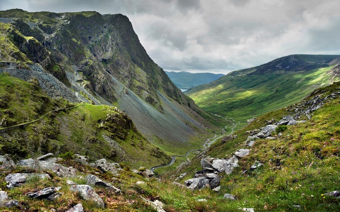 Mountain valley with winding river and sheep