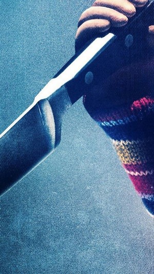 Chucky from Child's Play holding a knife