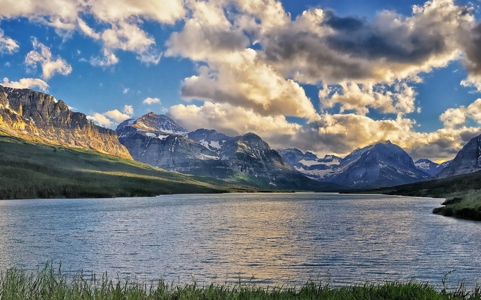 Lake and mountains under a cloudy sky