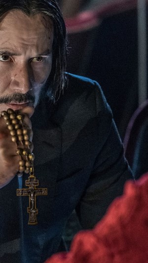 John Wick from John Wick 3 holding rosary beads
