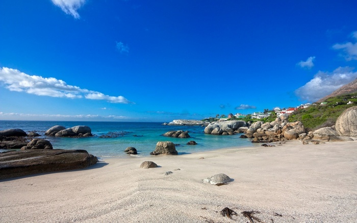 Beach with Boulders and Houses on Hillside