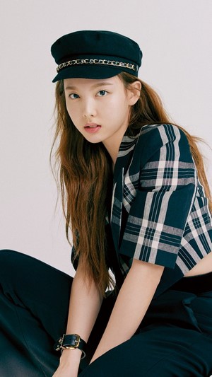 Nayeon from TWICE wearing a hat and plaid jacket