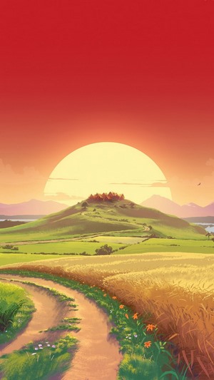 Sunrise over a hill with a village and fields