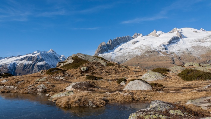 Snow-capped mountains and a frozen lake in a rocky landscape