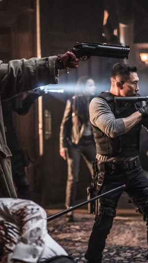 Ben Daimio from Hellboy holding a gun