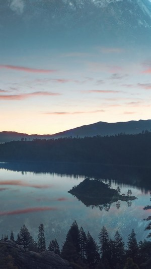 Mountain lake landscape with island at sunset