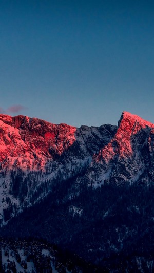 Snowy mountain peaks illuminated by sunset