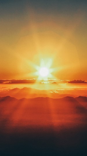 Sunset over mountains and clouds