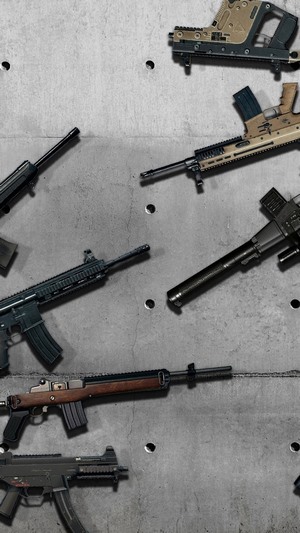 Various firearms on a concrete background