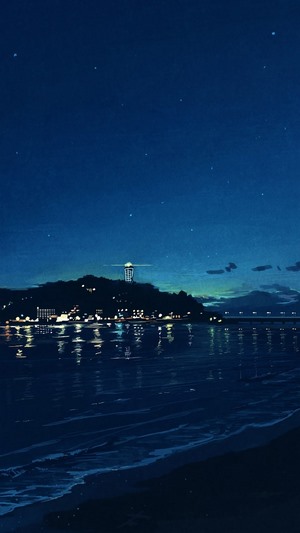 Night beach with a lighthouse and city lights