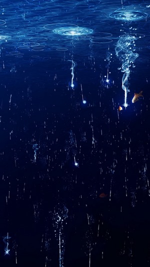 Fish swimming in dark blue water with glowing particles
