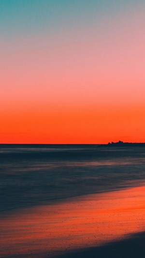 Sunset over the ocean with a beach