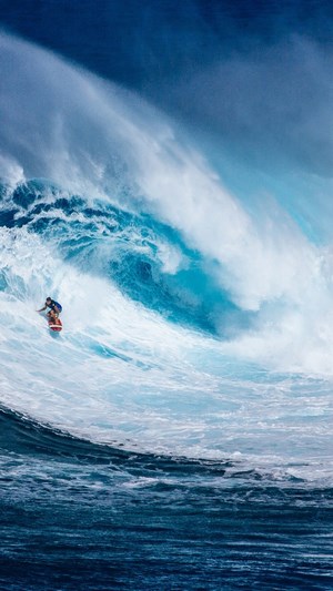 Surfer riding a large wave in the ocean