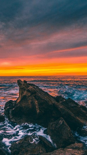 Sunset over the ocean with rocks