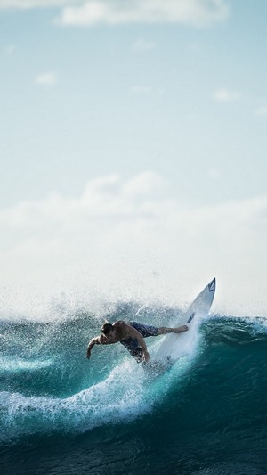 Surfer riding a wave in the ocean