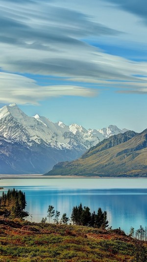 Snow-capped mountains reflected in a clear lake