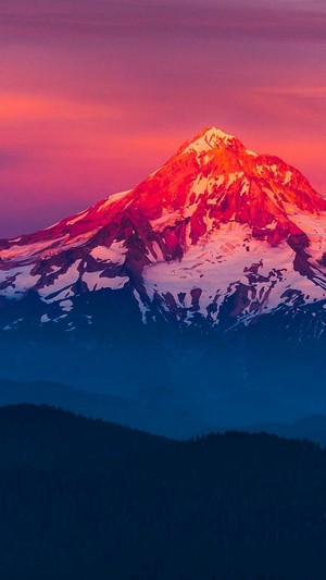 Snow-capped mountain at sunset